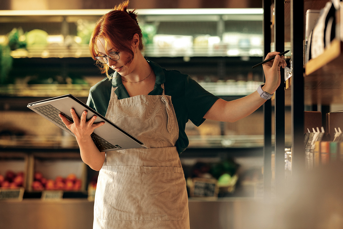 Retail employee holding a stylus and looking at the screen of a Galaxy Book PC